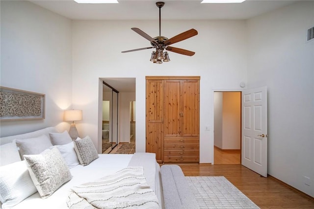 29111 Pompano Way, Laguna Niguel, CA 92677 - bedroom with a skylight, high vaulted ceiling, wood finished floors, and baseboards