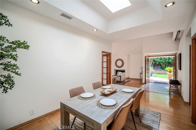 29111 Pompano Way, Laguna Niguel, CA 92677 - dining room with light wood-type flooring, a skylight, recessed lighting, baseboards, and a wall unit AC
