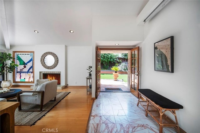 29111 Pompano Way, Laguna Niguel, CA 92677 - foyer with a warm lit fireplace, recessed lighting, a high ceiling, and light wood-style floors