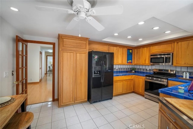 29111 Pompano Way, Laguna Niguel, CA 92677 - kitchen with stainless steel appliances, recessed lighting, decorative backsplash, brown cabinets, and a ceiling fan