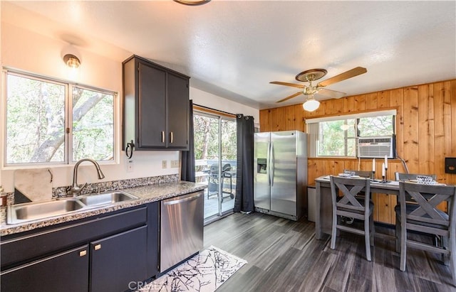 29148 Lyon Dr, Cedar Glen, CA 92321 - kitchen featuring appliances with stainless steel finishes, a sink, plenty of natural light, wooden walls, and cooling unit