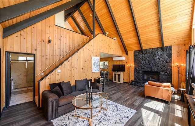 29148 Lyon Dr, Cedar Glen, CA 92321 - living area with wooden walls, a wall mounted air conditioner, wood ceiling with exposed beams, wood finished floors, and high vaulted ceiling