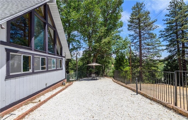29148 Lyon Dr, Cedar Glen, CA 92321 - view of property exterior featuring a shingled roof, a fenced backyard, a patio area, and crawl space