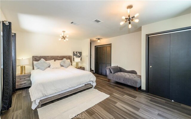 29148 Lyon Dr, Cedar Glen, CA 92321 - bedroom featuring a chandelier, two closets, and wood finished floors