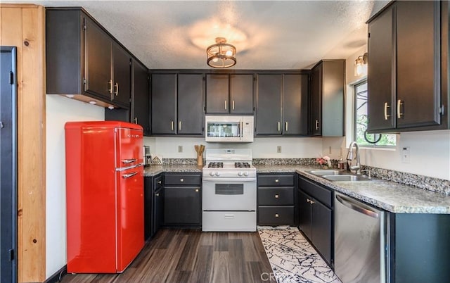 29148 Lyon Dr, Cedar Glen, CA 92321 - kitchen with white appliances, a sink, and dark wood-style floors