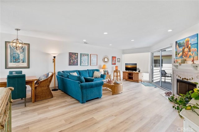 718 W 37th St Unit 4, San Pedro, CA 90731 - living area with light wood-style floors, a fireplace, a chandelier, and recessed lighting