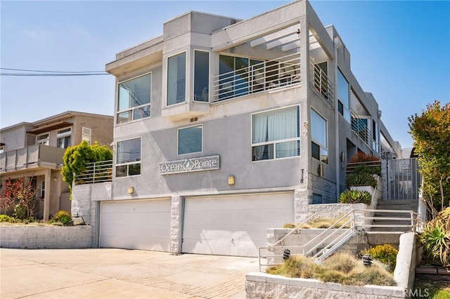 718 W 37th St Unit 4, San Pedro, CA 90731 - view of front of property featuring a garage, driveway, stucco siding, stairs, and a balcony