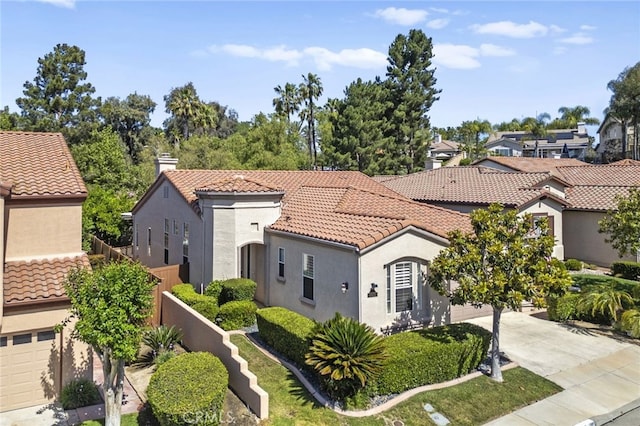 41799 Cascades Ct, Temecula, CA 92591 - mediterranean / spanish house with stucco siding, a tile roof, driveway, a residential view, and a chimney