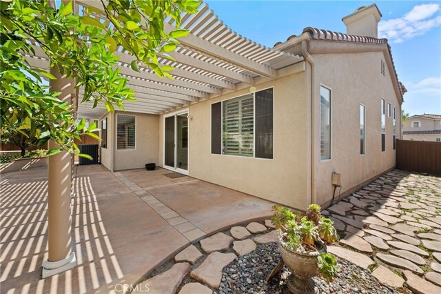 41799 Cascades Ct, Temecula, CA 92591 - back of property featuring a chimney, a pergola, a patio, and stucco siding