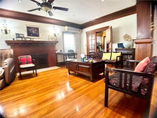 867 S Bronson Ave, Los Angeles, CA 90005 - living room with a wall mounted air conditioner, wood finished floors, ceiling fan, ornamental molding, and a fireplace
