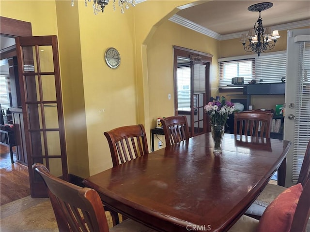 867 S Bronson Ave, Los Angeles, CA 90005 - dining space with a chandelier, arched walkways, and crown molding