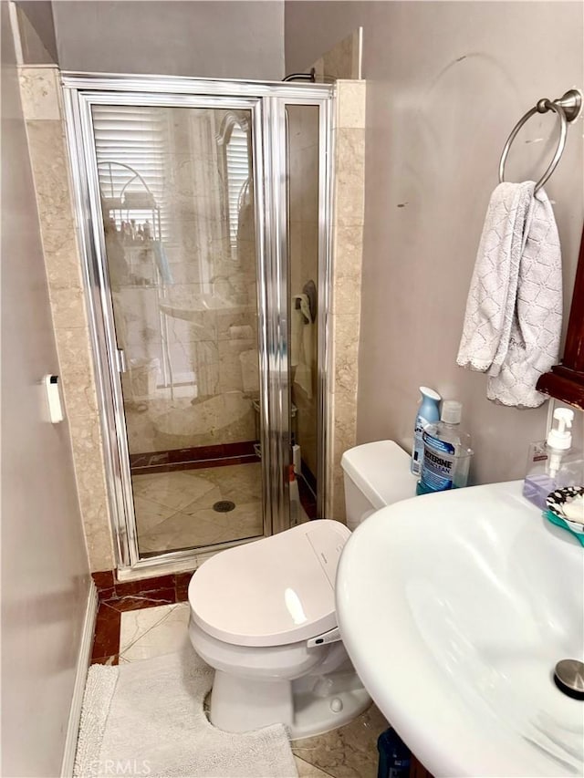 867 S Bronson Ave, Los Angeles, CA 90005 - full bath featuring a shower stall, toilet, a sink, and marble finish floors