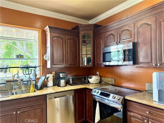 867 S Bronson Ave, Los Angeles, CA 90005 - kitchen featuring appliances with stainless steel finishes, a sink, light stone counters, glass insert cabinets, and crown molding