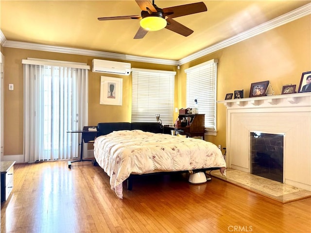 867 S Bronson Ave, Los Angeles, CA 90005 - bedroom featuring a wall mounted air conditioner, hardwood / wood-style floors, ornamental molding, a fireplace with raised hearth, and a ceiling fan