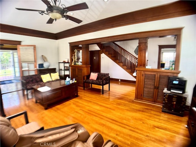 867 S Bronson Ave, Los Angeles, CA 90005 - living area with stairs, ceiling fan, light wood-style floors, decorative columns, and ornamental molding
