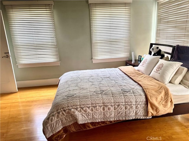 867 S Bronson Ave, Los Angeles, CA 90005 - bedroom with wood finished floors and multiple windows