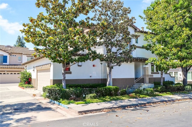 2348 Sunningdale Dr, Tustin, CA 92782 - view of front of home featuring stucco siding, concrete driveway, and an attached garage