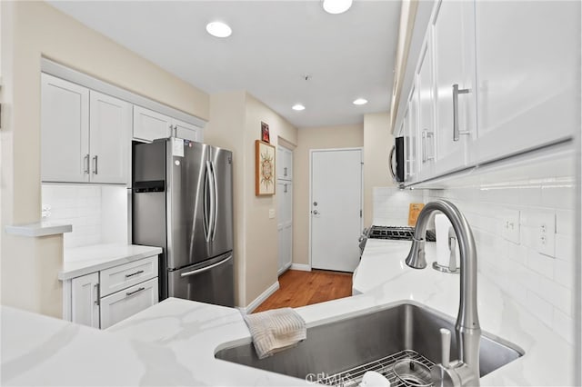 2348 Sunningdale Dr, Tustin, CA 92782 - kitchen with stainless steel appliances, white cabinets, backsplash, light stone countertops, and recessed lighting