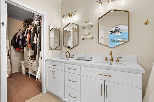 2348 Sunningdale Dr, Tustin, CA 92782 - bathroom featuring double vanity, a walk in closet, a ceiling fan, and tile patterned floors