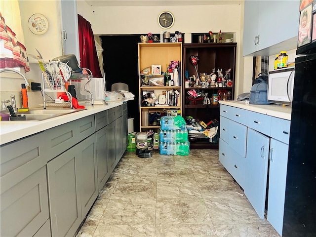 122 E Pioneer Ave, Redlands, CA 92374 - kitchen with a sink, light countertops, gray cabinets, and white microwave