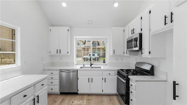 7059 Potenza Pl, Rancho Cucamonga, CA 91701 - kitchen with appliances with stainless steel finishes, a sink, white cabinetry, light countertops, and recessed lighting