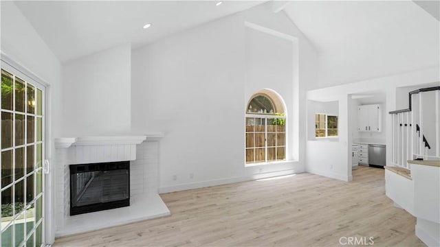 7059 Potenza Pl, Rancho Cucamonga, CA 91701 - unfurnished living room with high vaulted ceiling, a brick fireplace, wood finished floors, baseboards, and recessed lighting