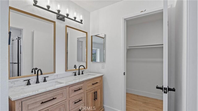 7059 Potenza Pl, Rancho Cucamonga, CA 91701 - bathroom with double vanity, wood finished floors, and baseboards
