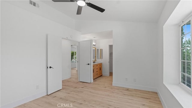 7059 Potenza Pl, Rancho Cucamonga, CA 91701 - unfurnished bedroom with vaulted ceiling, light wood-style flooring, baseboards, connected bathroom, and ceiling fan