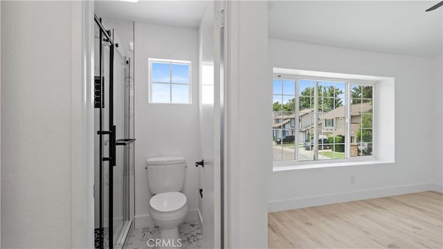 7059 Potenza Pl, Rancho Cucamonga, CA 91701 - bathroom featuring plenty of natural light, toilet, a stall shower, and baseboards