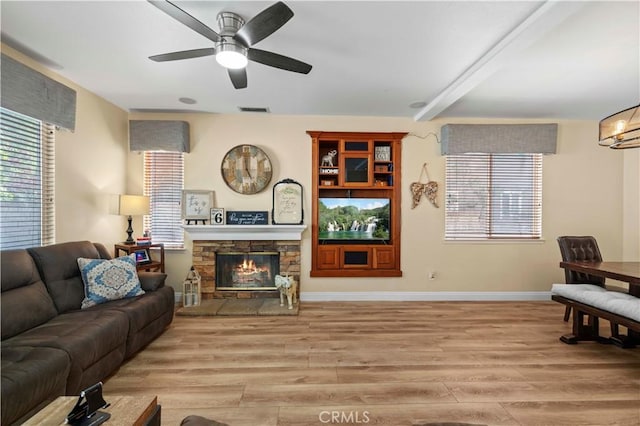 28436 Calex Dr, Valencia, CA 91354 - living area featuring light wood finished floors, ceiling fan, a stone fireplace, and baseboards