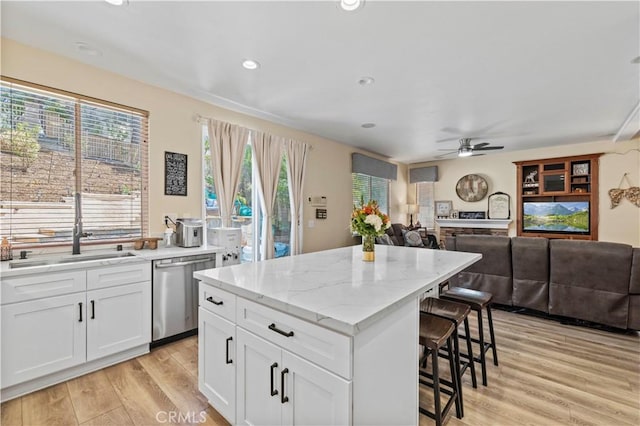 28436 Calex Dr, Valencia, CA 91354 - kitchen with dishwasher, a kitchen breakfast bar, a sink, light wood finished floors, and ceiling fan