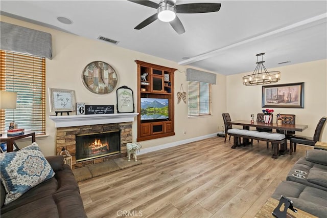 28436 Calex Dr, Valencia, CA 91354 - living area featuring a chandelier, light wood-type flooring, a ceiling fan, baseboards, and a fireplace