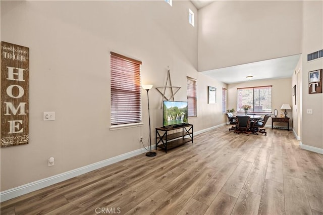 28436 Calex Dr, Valencia, CA 91354 - living room with wood finished floors, baseboards, and a towering ceiling