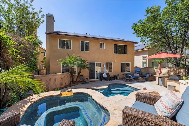28436 Calex Dr, Valencia, CA 91354 - rear view of property with an in-ground hot tub, an outdoor pool, a patio area, a chimney, and stucco siding