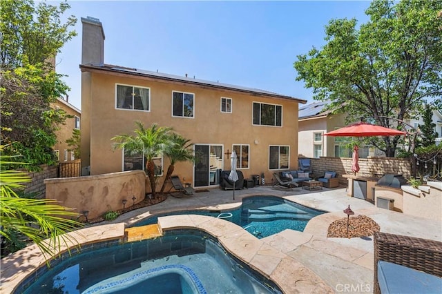 28436 Calex Dr, Valencia, CA 91354 - rear view of house featuring an in-ground hot tub, a patio, a chimney, stucco siding, and an outdoor living space