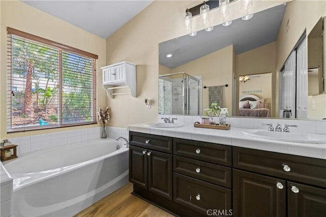 28436 Calex Dr, Valencia, CA 91354 - ensuite bathroom with double vanity, a garden tub, a stall shower, and wood finished floors