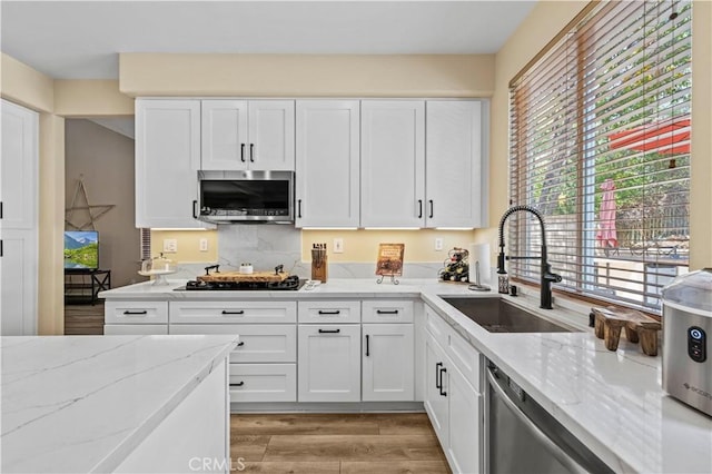 28436 Calex Dr, Valencia, CA 91354 - kitchen with a sink, stainless steel appliances, light stone countertops, and white cabinetry