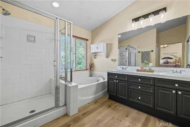 28436 Calex Dr, Valencia, CA 91354 - ensuite bathroom with a shower stall, double vanity, a garden tub, and wood finished floors
