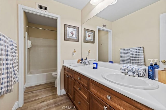 28436 Calex Dr, Valencia, CA 91354 - bathroom featuring double vanity, wood finished floors, toilet, and shower / tub combination