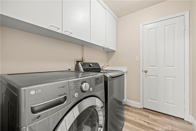 28436 Calex Dr, Valencia, CA 91354 - laundry area with cabinet space, washing machine and dryer, light wood-style flooring, and baseboards