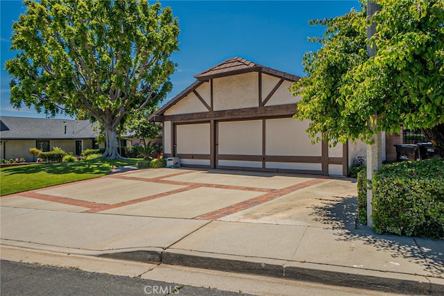 751 Santa Fe Ct, San Dimas, CA 91773 - tudor-style house with driveway, a garage, stucco siding, and a front yard