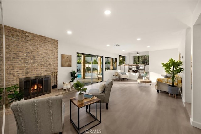 5622 Revere Ave, Rancho Cucamonga, CA 91737 - living area featuring wood finished floors, recessed lighting, and a brick fireplace