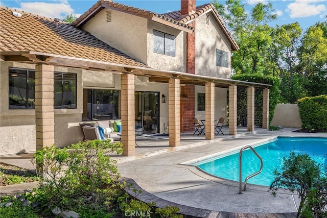 5622 Revere Ave, Rancho Cucamonga, CA 91737 - rear view of house with stucco siding, a patio area, a tiled roof, and a chimney