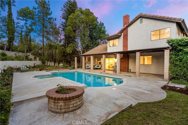 5622 Revere Ave, Rancho Cucamonga, CA 91737 - pool at dusk with a patio area and an outdoor fire pit