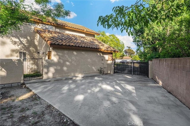 5622 Revere Ave, Rancho Cucamonga, CA 91737 - view of side of property featuring a gate, stucco siding, and a tiled roof