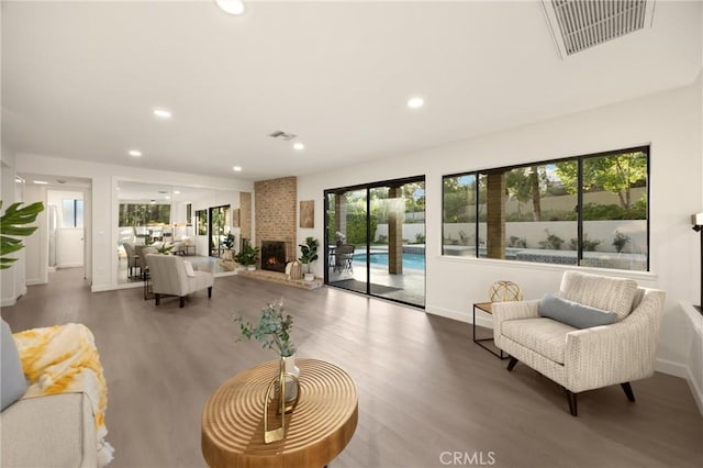 5622 Revere Ave, Rancho Cucamonga, CA 91737 - living room featuring wood finished floors, a brick fireplace, and recessed lighting