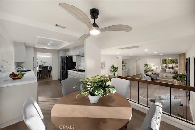 5622 Revere Ave, Rancho Cucamonga, CA 91737 - dining space with recessed lighting, wood finished floors, a ceiling fan, and a raised ceiling