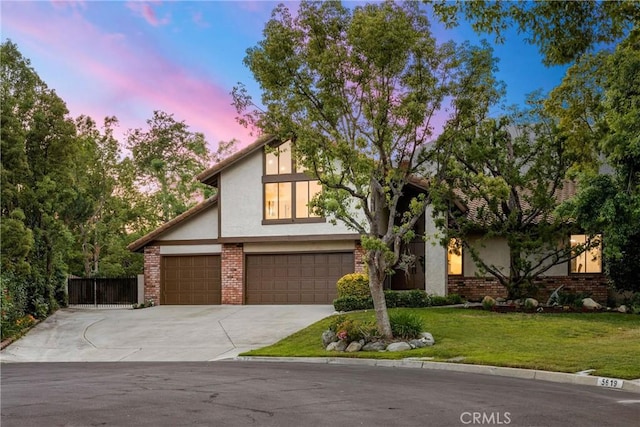5622 Revere Ave, Rancho Cucamonga, CA 91737 - view of front of house featuring stucco siding, concrete driveway, a garage, a yard, and brick siding