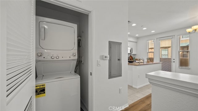 410 W Main St Unit 231, Alhambra, CA 91801 - laundry area featuring stacked washer and clothes dryer, recessed lighting, electric panel, and wood finished floors