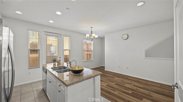 410 W Main St Unit 231, Alhambra, CA 91801 - kitchen with stainless steel appliances, a sink, white cabinets, a kitchen island with sink, and a chandelier